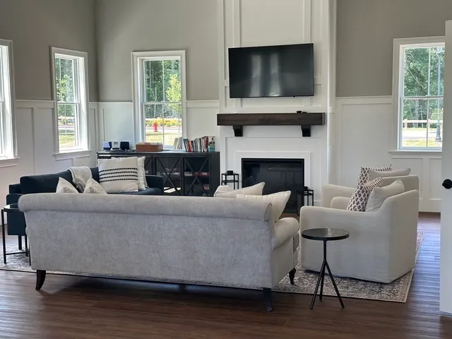 a living room with furniture flat screen tv and a fireplace