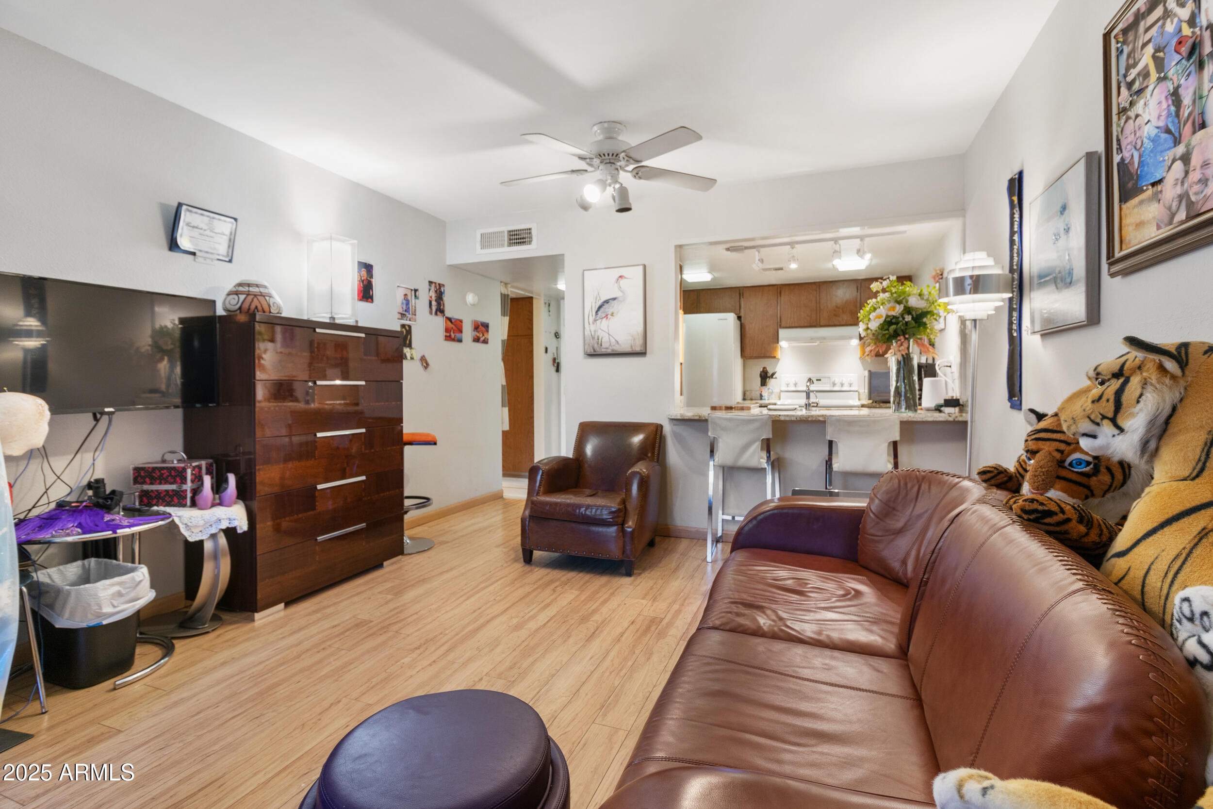 3033 East Devonshire Avenue, Unit 3003 Phoenix, AZ 85016 - Photo 13 of 45 a living room with furniture and a flat screen tv