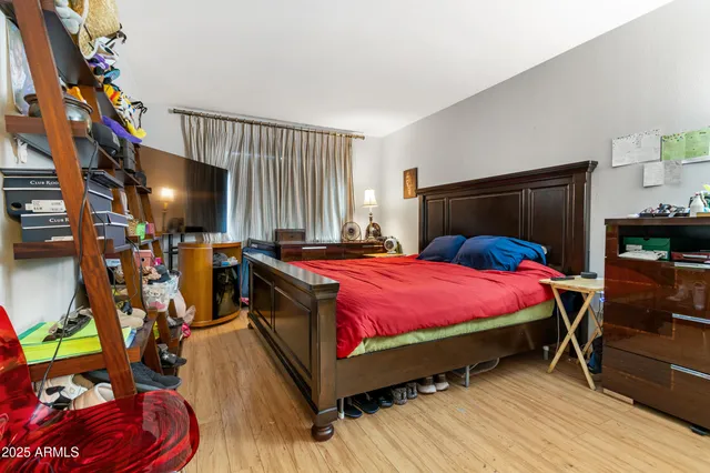 a bedroom with a bed and a mirror