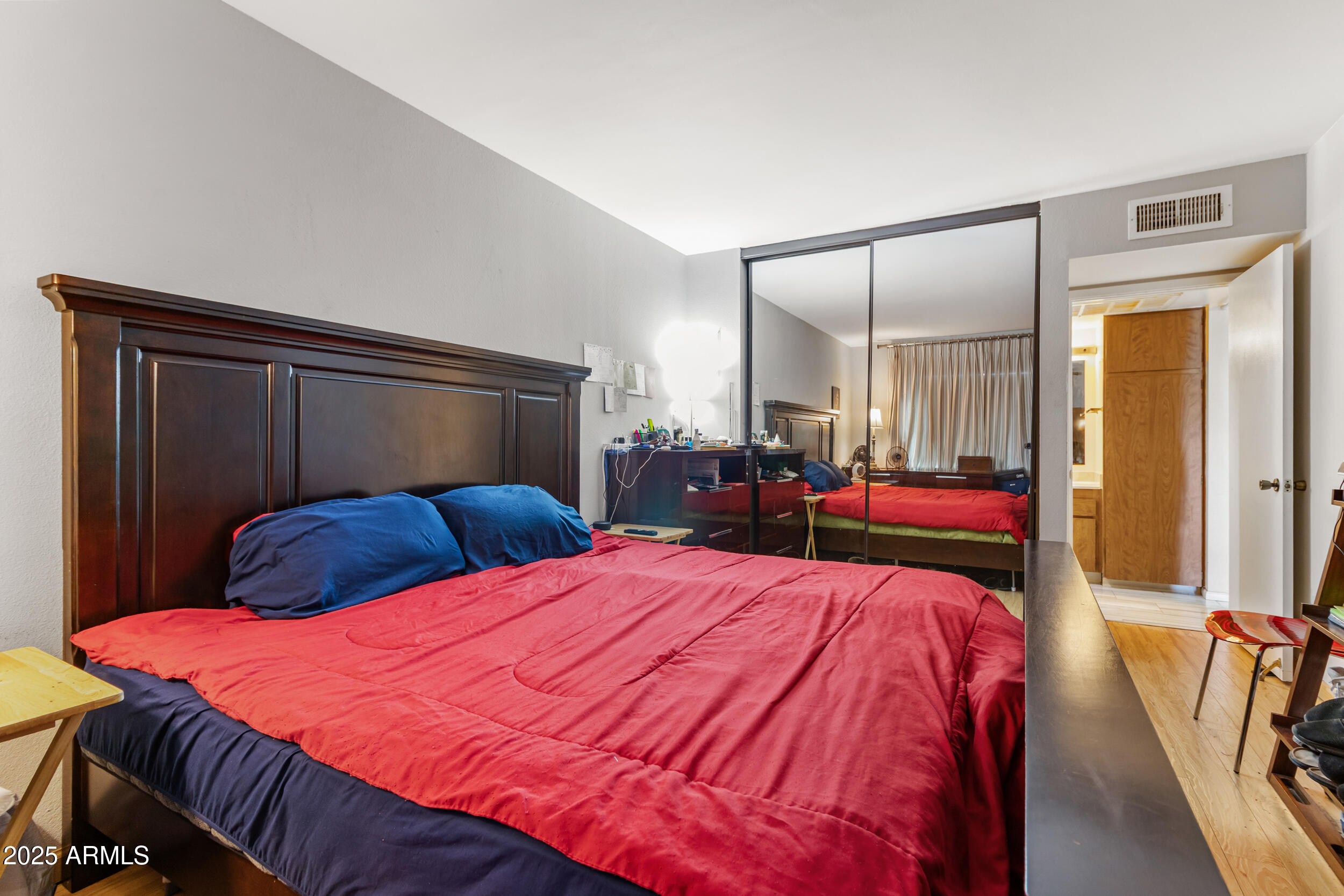 3033 East Devonshire Avenue, Unit 3003 Phoenix, AZ 85016 - Photo 15 of 45 a bedroom with a bed and a mirror