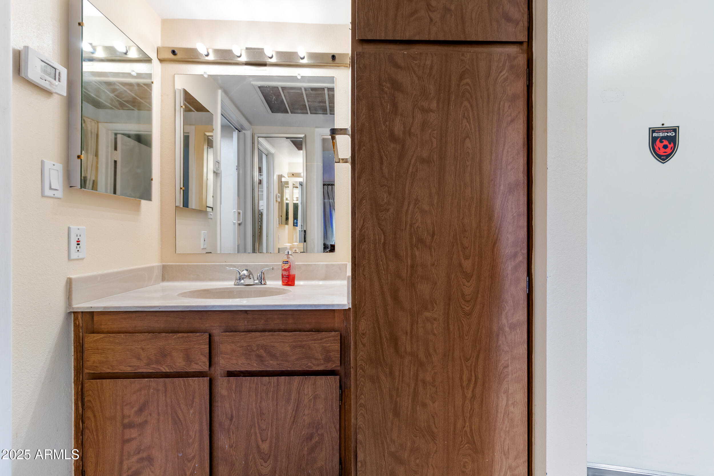 3033 East Devonshire Avenue, Unit 3003 Phoenix, AZ 85016 - Photo 17 of 45 a bathroom with a sink and a mirror