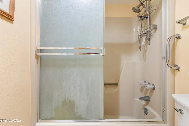 a bathroom with a bathtub and shower