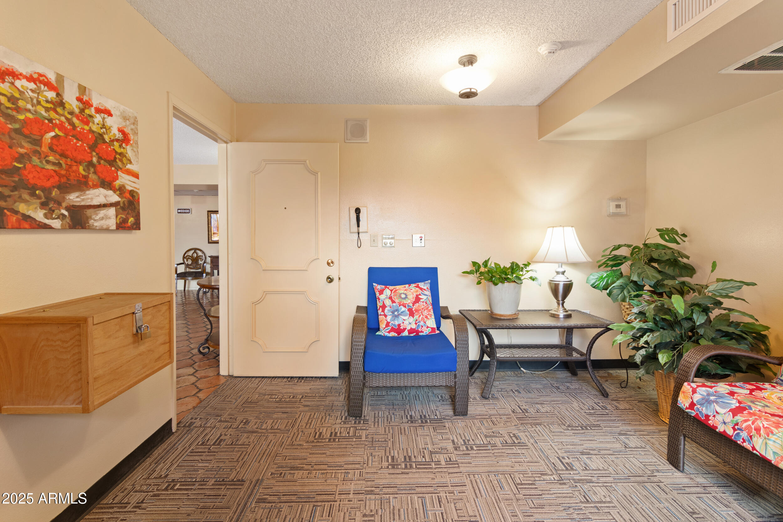 3033 East Devonshire Avenue, Unit 3003 Phoenix, AZ 85016 - Photo 23 of 45 a living room with furniture and flowers