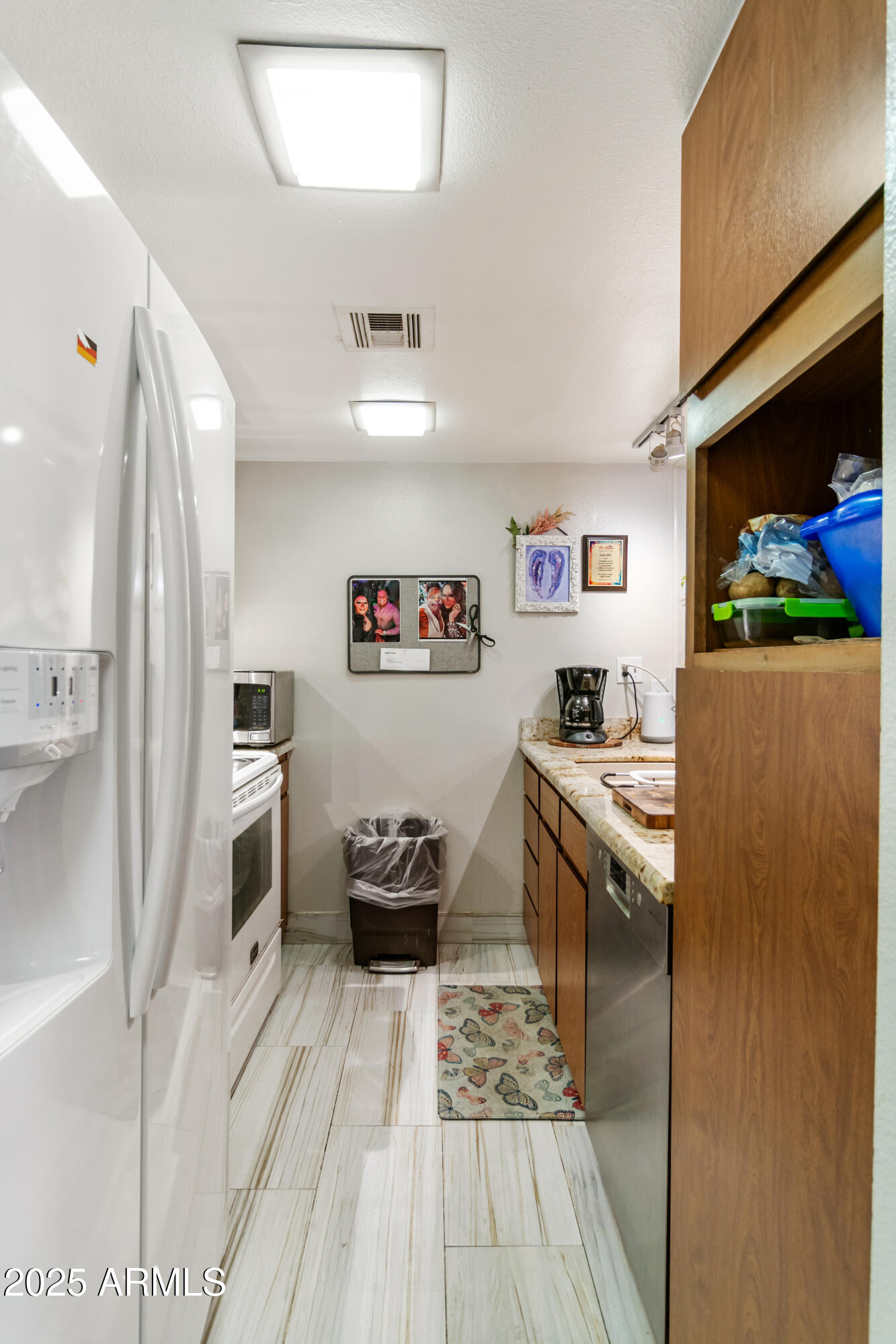 3033 East Devonshire Avenue, Unit 3003 Phoenix, AZ 85016 - Photo 6 of 45 a kitchen with stainless steel appliances a stove a refrigerator and a refrigerator