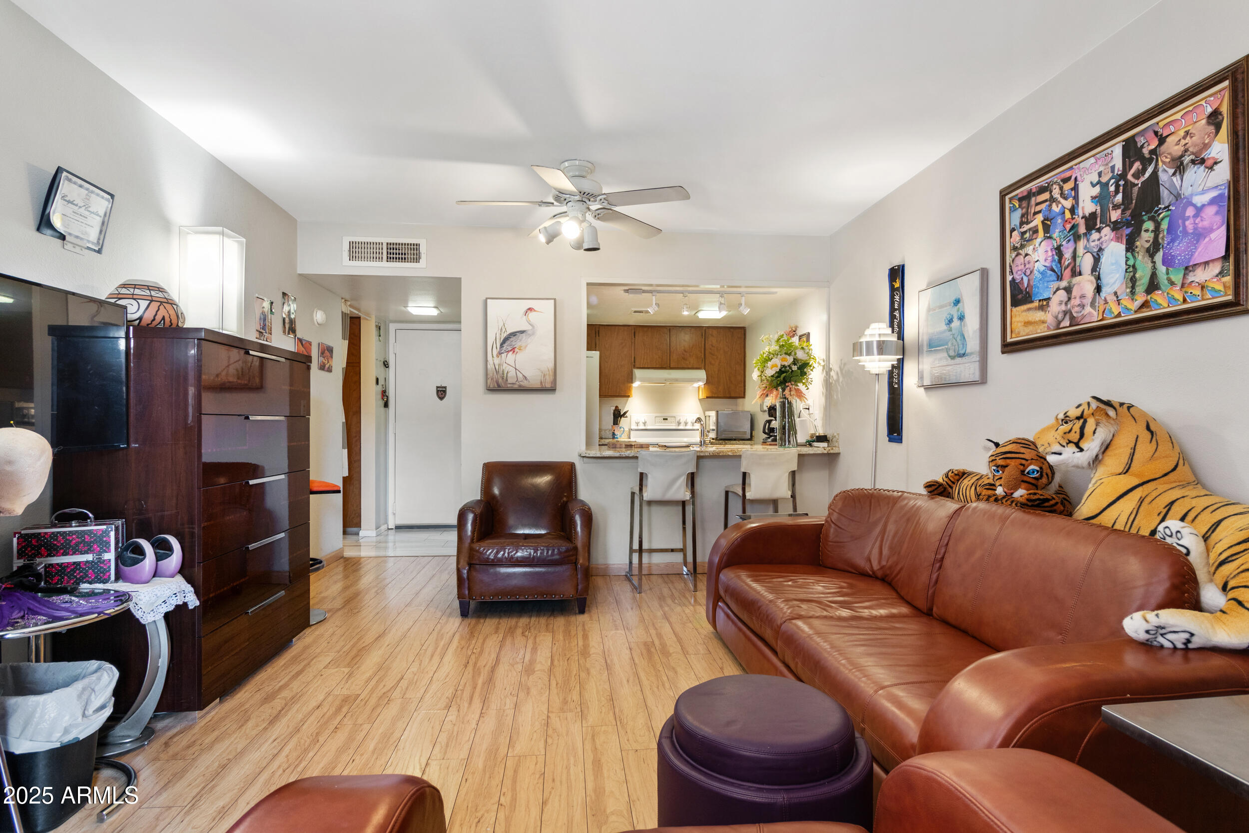3033 East Devonshire Avenue, Unit 3003 Phoenix, AZ 85016 - Photo 8 of 45 a living room with furniture ceiling fan and a wooden floor