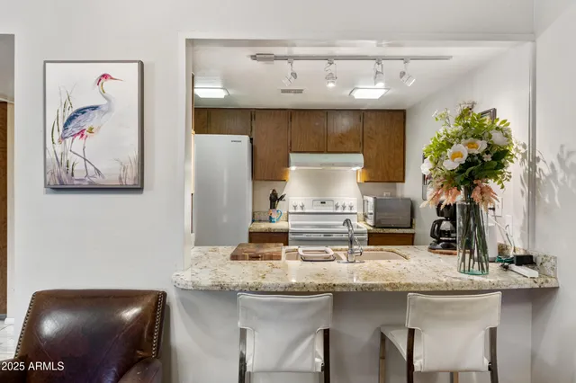 a room with a bed and a refrigerator