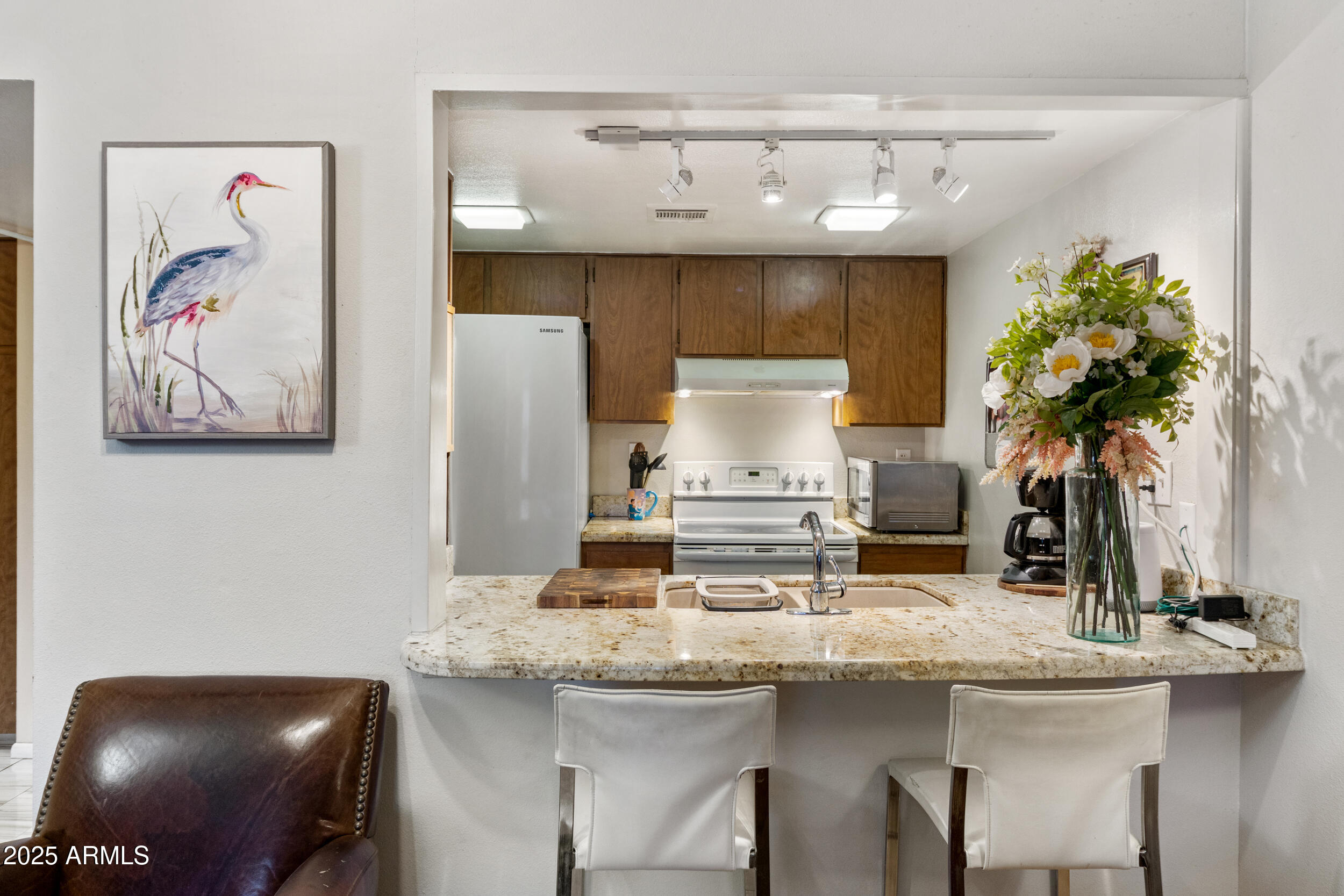 3033 East Devonshire Avenue, Unit 3003 Phoenix, AZ 85016 - Photo 9 of 45 a kitchen with a sink and cabinets