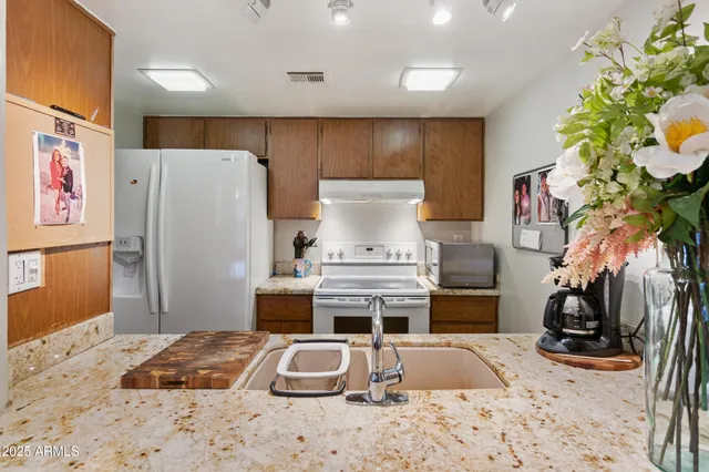 a kitchen with a stove and a refrigerator