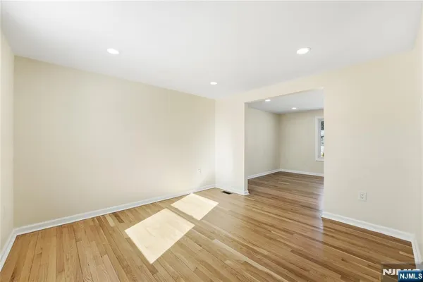 a view of an empty room and wooden floor