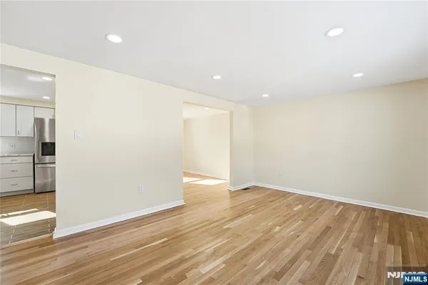 a view of an empty room with wooden floor