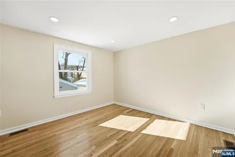 a view of a room with wooden floor and closet