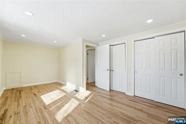 a view of a room with wooden floor and closet