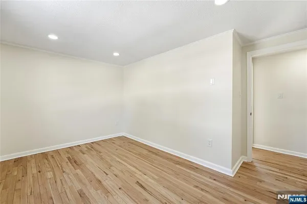 a view of room with wooden floor
