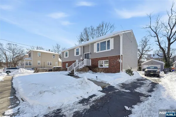 a view of a house with a yard covered in snow