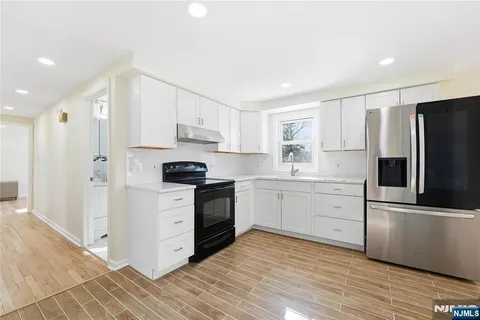 a view of an empty room and wooden floor