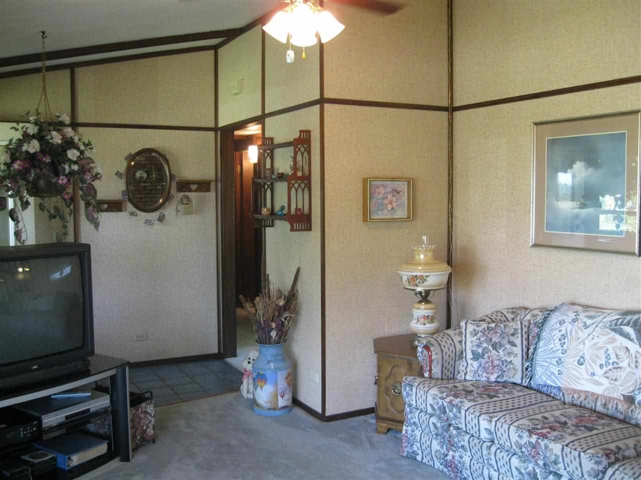 7114 Stephens Road Rockton, IL 61072 - Photo 5 of 20 a living room with furniture and a flat screen tv