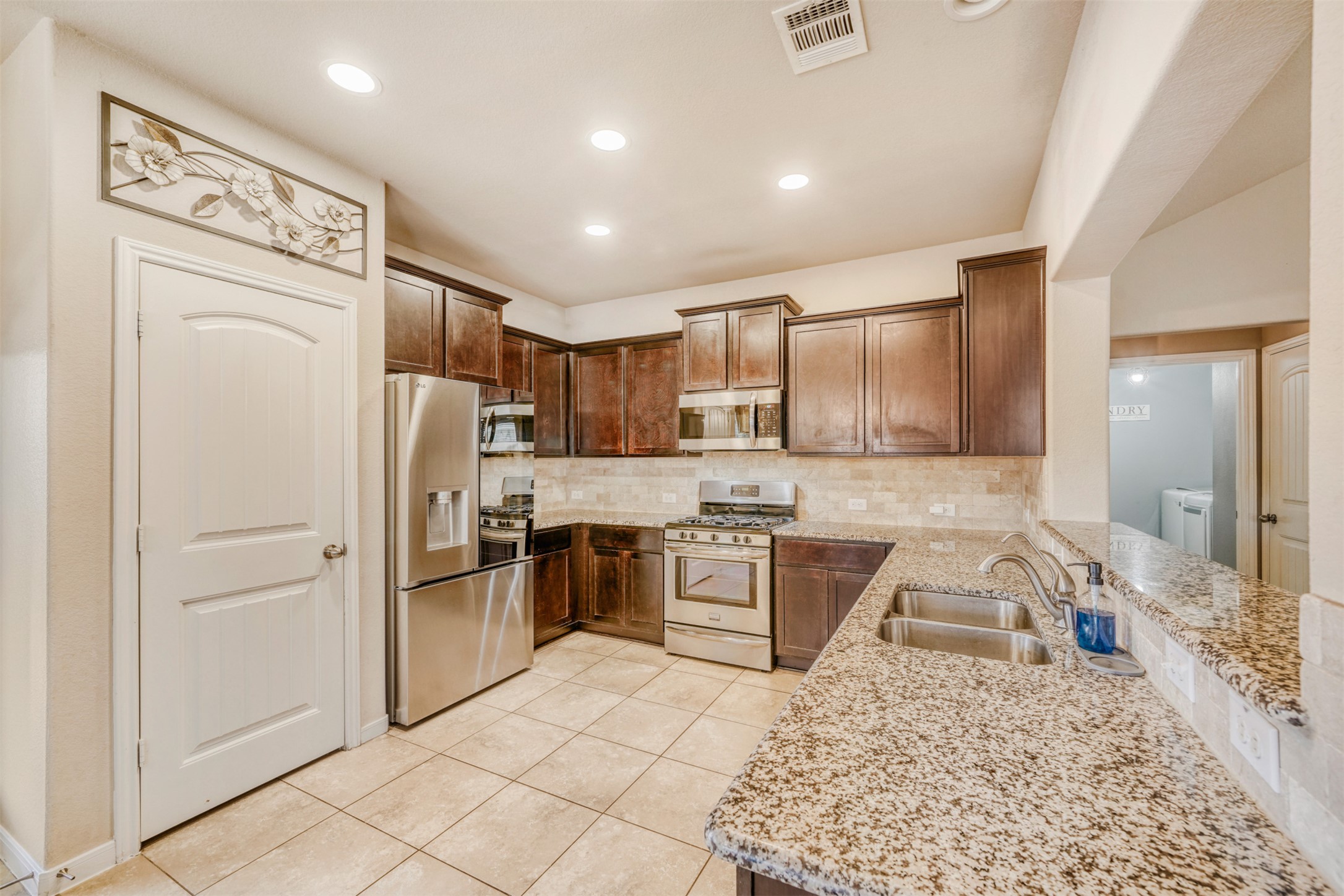 952 Palo Duro Loop Round Rock, TX 78664 - Photo 15 of 37 a kitchen with a refrigerator a stove top oven and a sink