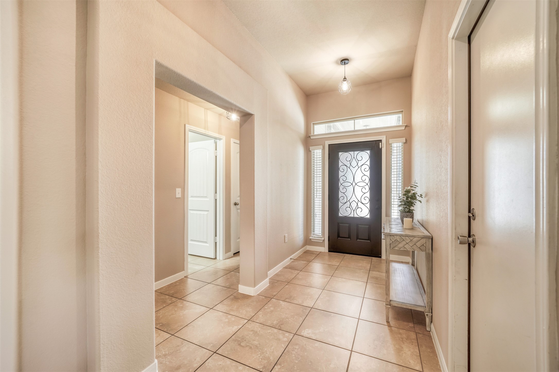 952 Palo Duro Loop Round Rock, TX 78664 - Photo 7 of 37 a view of a hallway with wooden floor and a livingroom
