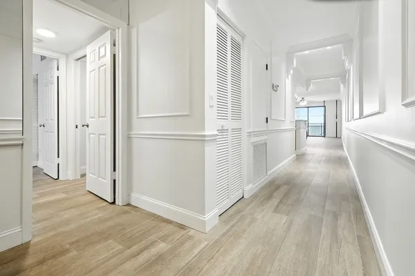 a view of a kitchen with a refrigerator and a stove top oven