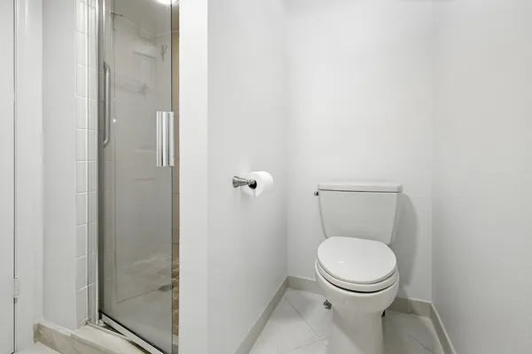 a white toilet sitting next to a bathroom sink