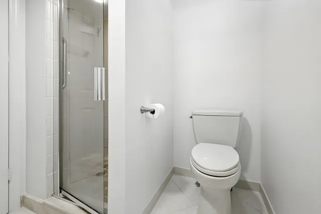 a white toilet sitting next to a bathroom sink