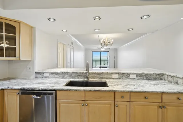 a kitchen with a sink and chandelier