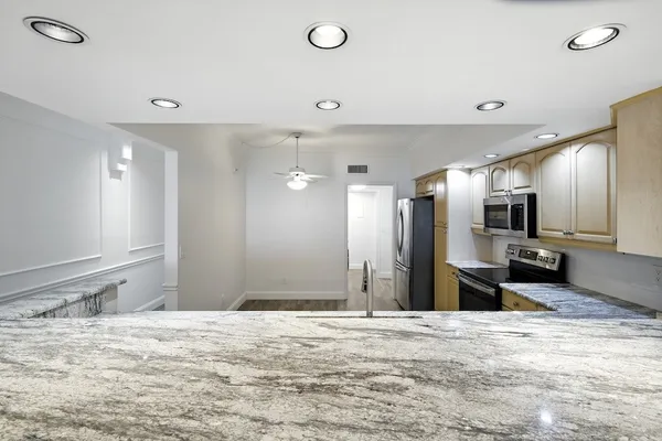 a large room with a refrigerator and a sink