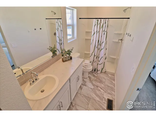 a bathroom with a sink vanity granite and a mirror