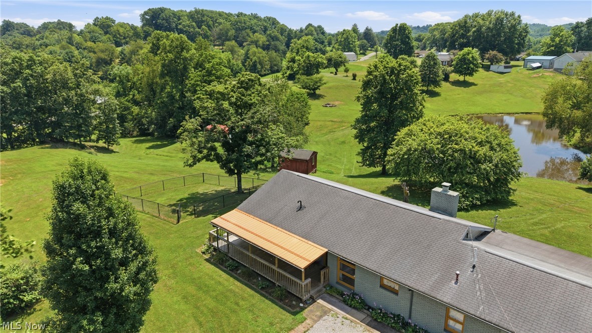 89 Dagg Road Parkersburg, WV 26101 - Photo 40 of 45 Expansive green lawn with mature trees and a tranquil pond