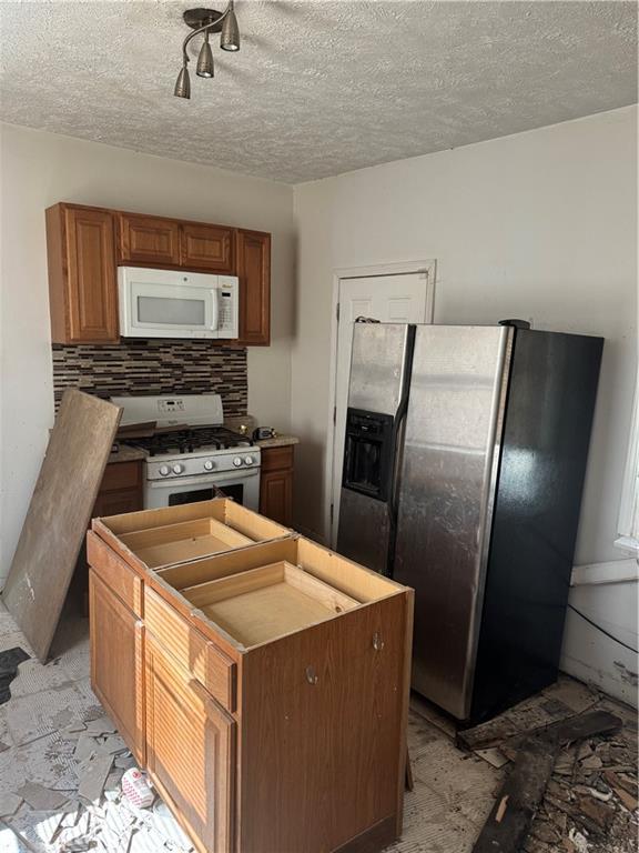 628 Church St Extension Turtle Creek, PA 15145 - Photo 6 of 12 a kitchen with stainless steel appliances granite countertop a refrigerator a stove and a sink