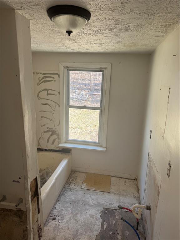 628 Church St Extension Turtle Creek, PA 15145 - Photo 7 of 12 a bathroom with a bathtub and a shower