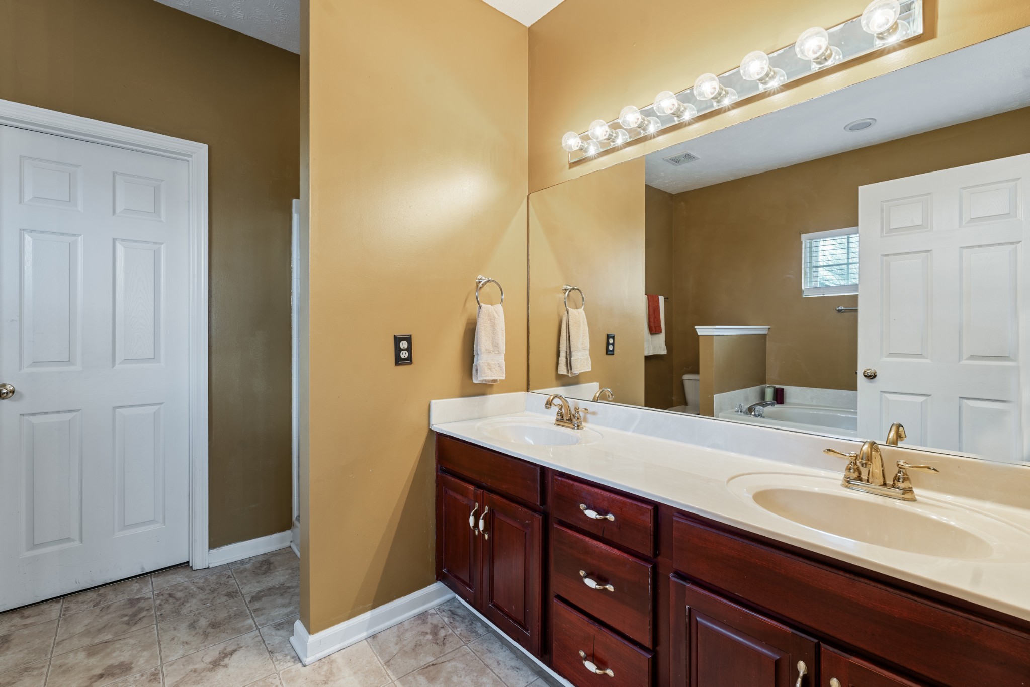 7105 Smokey Hill Road Antioch, TN 37013 - Photo 19 of 30 a bathroom with a double vanity sink and a mirror