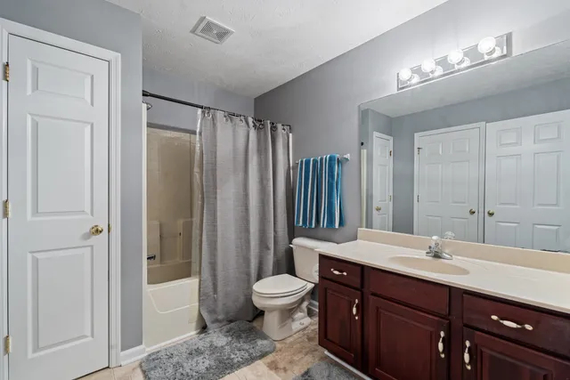 a bathroom with a toilet a sink and a mirror