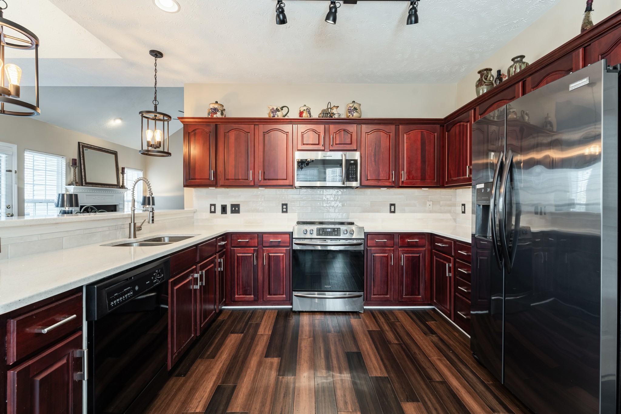 7105 Smokey Hill Road Antioch, TN 37013 - Photo 9 of 30 a kitchen with stainless steel appliances granite countertop a refrigerator a sink dishwasher a stove and white countertops with cabinets