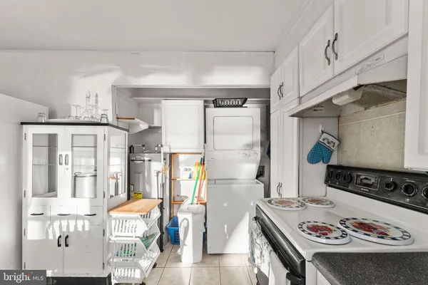 a kitchen with stainless steel appliances granite countertop a refrigerator and a stove