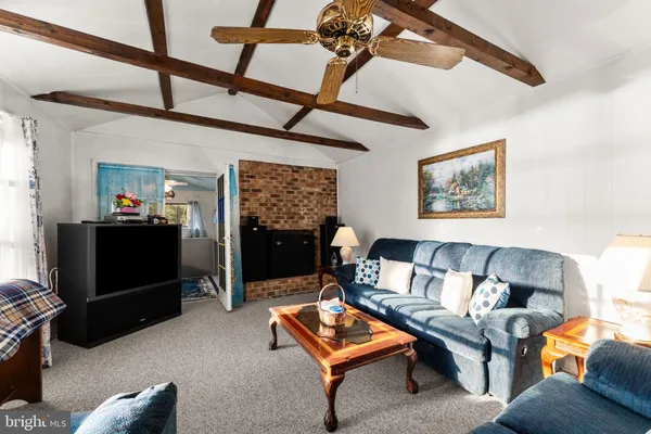 a living room with furniture a rug and a flat screen tv