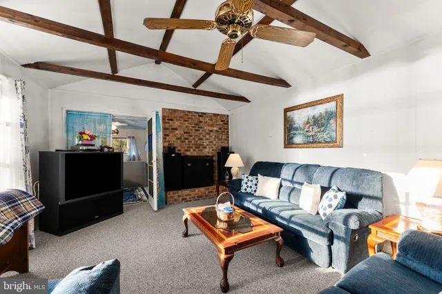 a living room with furniture a rug and a flat screen tv