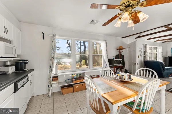 a dining room with furniture a chandelier and wooden floor