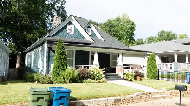 a front view of a house with garden and porch