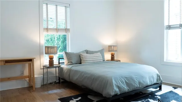 a bedroom with a bed and windows