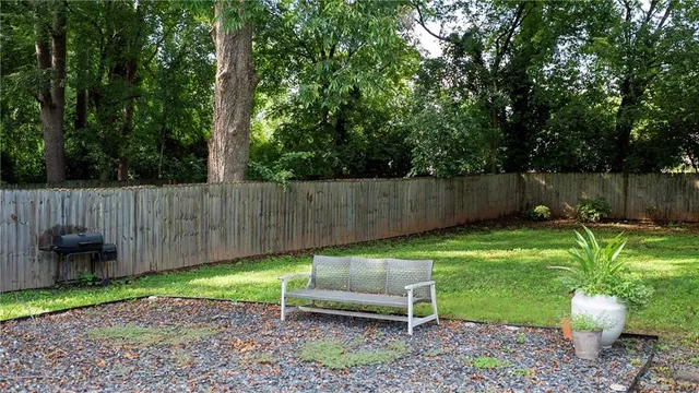 a view of a backyard with furniture and a garden