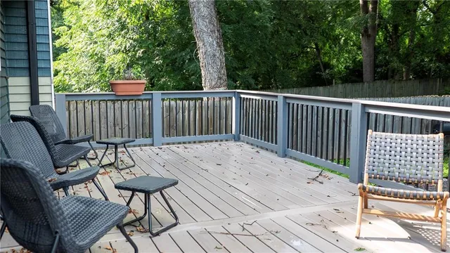 a view of balcony with wooden floor and outdoor seating