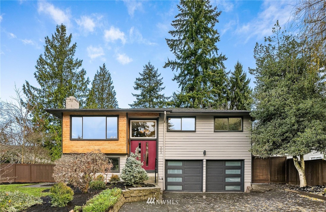 303 217th Place Southwest Bothell, WA 98021 - Photo 1 of 38 a front view of a house with a garden