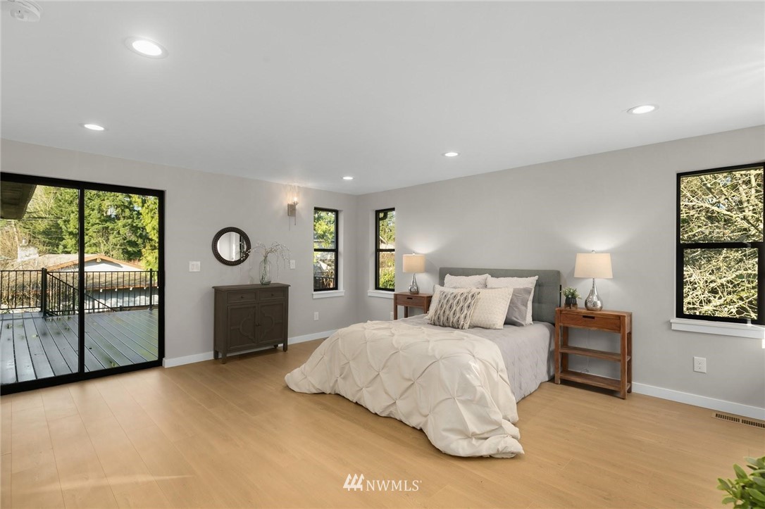 303 217th Place Southwest Bothell, WA 98021 - Photo 16 of 38 a bedroom with a large bed and a table