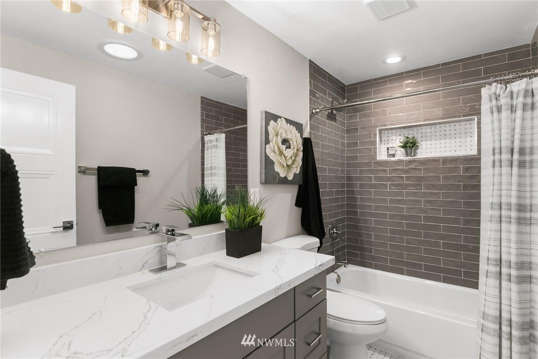 303 217th Place Southwest Bothell, WA 98021 - Photo 22 of 38 a bathroom with a granite countertop sink toilet and shower