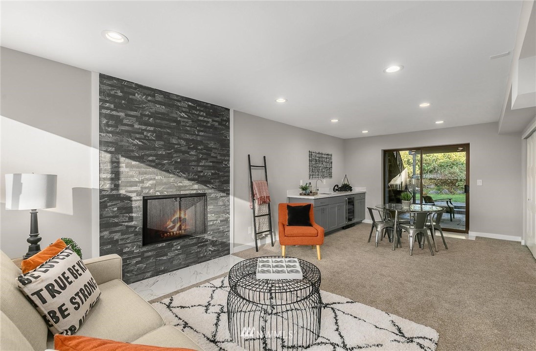 303 217th Place Southwest Bothell, WA 98021 - Photo 25 of 38 a living room with furniture and a fireplace
