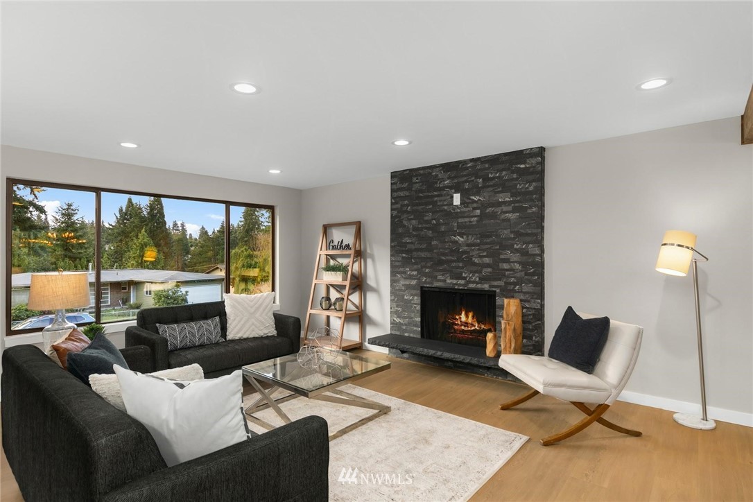 303 217th Place Southwest Bothell, WA 98021 - Photo 4 of 38 a living room with furniture and a fireplace