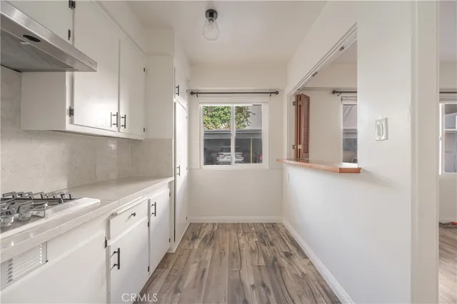 a kitchen with sink cabinets and window