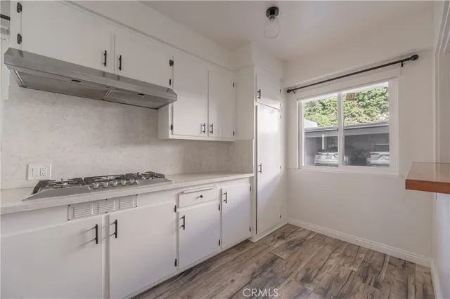 a kitchen with granite countertop white cabinets and white appliances