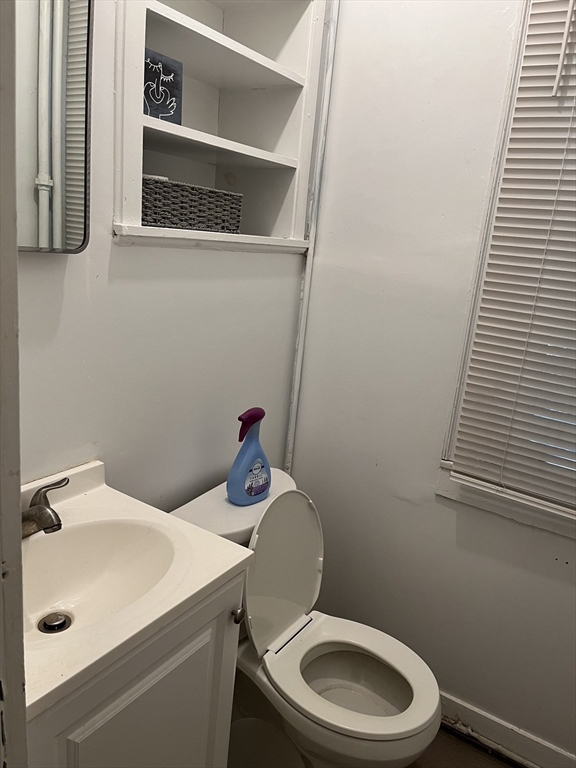 152 Strathmore Road, Unit 2 Boston, MA 02135 - Photo 5 of 5 a bathroom with a sink a toilet and a mirror